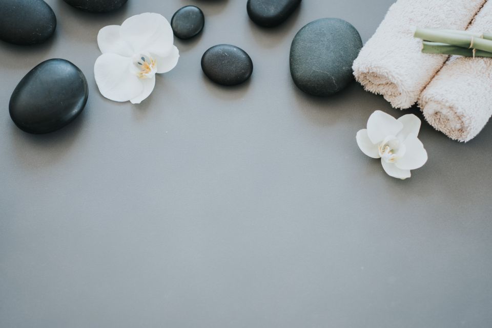 Hot stones, orchid and towels with calm empty space